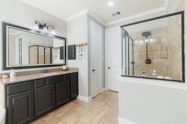 bathroom featuring a shower with shower door, vanity, and crown molding