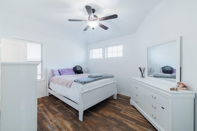 bedroom with multiple windows, ceiling fan, and dark hardwood / wood-style flooring