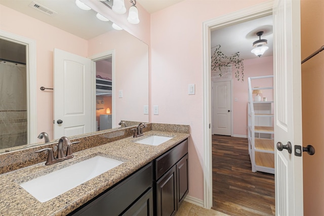 bathroom with hardwood / wood-style floors and vanity