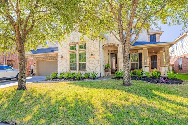 view of front facade with brick siding, concrete driveway, a front yard, a garage, and stone siding