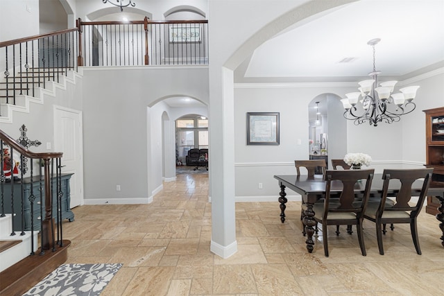 dining area with stone tile flooring, visible vents, stairway, and baseboards