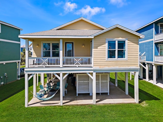 back of property with a patio area and a lawn