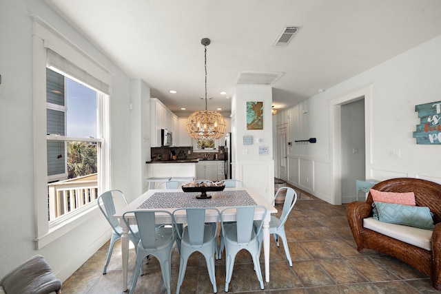 dining space featuring an inviting chandelier