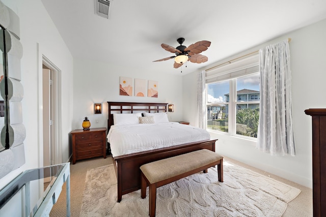 bedroom featuring light colored carpet and ceiling fan