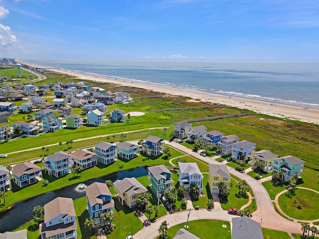 birds eye view of property with a water view and a beach view