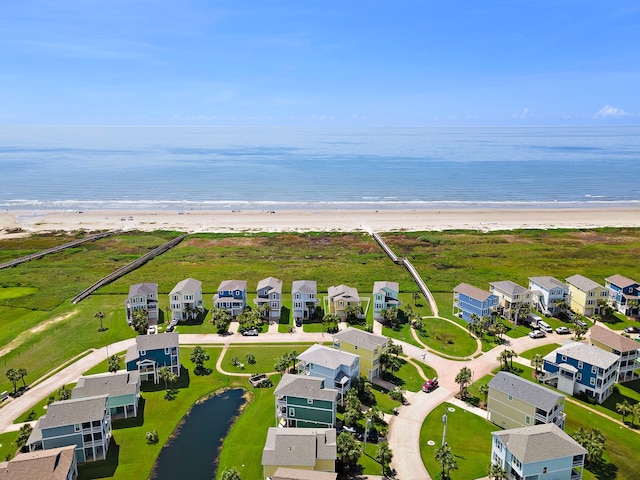 drone / aerial view with a water view and a view of the beach