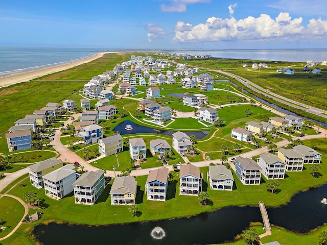 birds eye view of property featuring a water view and a beach view