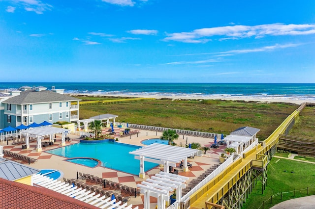 view of swimming pool featuring a pergola, a patio, a water view, a view of the beach, and a hot tub