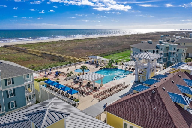 birds eye view of property featuring a beach view and a water view