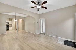 unfurnished living room featuring ceiling fan and hardwood / wood-style floors