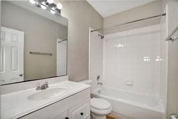 full bathroom with toilet, shower / tub combination, and vanity