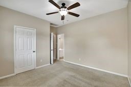 unfurnished bedroom featuring ceiling fan and light carpet