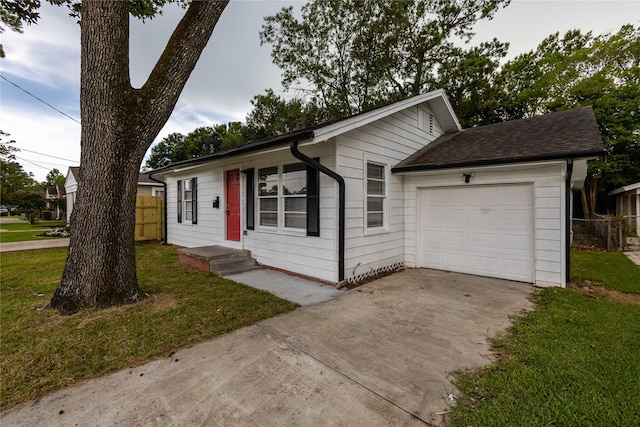 ranch-style house featuring a garage and a front yard