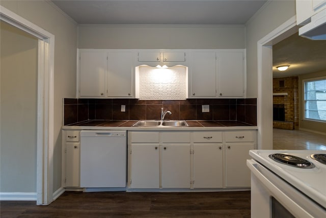 kitchen featuring white appliances, white cabinetry, tasteful backsplash, sink, and tile countertops