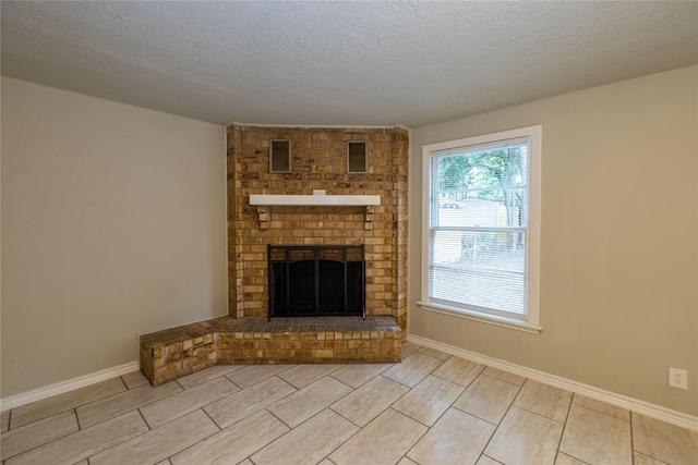 unfurnished living room with a textured ceiling and a fireplace