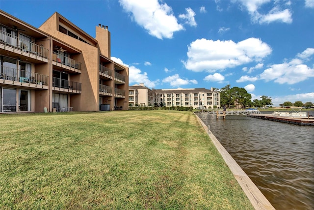 view of property with a water view and central AC