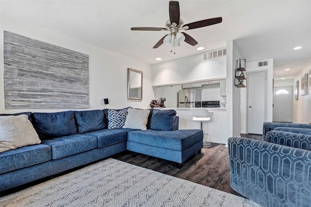 living room with ceiling fan and wood-type flooring