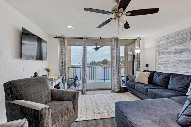 living room featuring ceiling fan and wood-type flooring