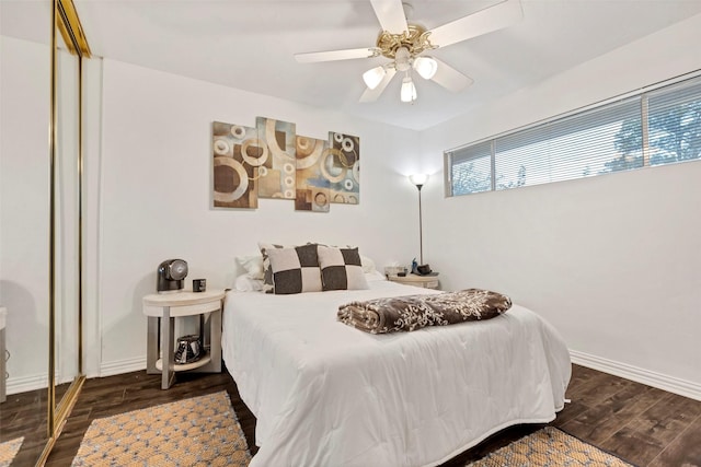 bedroom with dark wood-type flooring, a closet, and ceiling fan