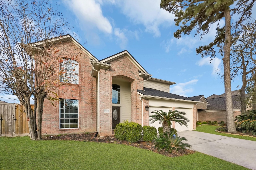 view of front of home with a garage and a front yard