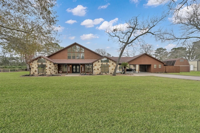 28540 Lynnwood Ln, Hempstead, TX 77445 - view of front of house featuring concrete driveway, french doors, stone siding, and an attached carport