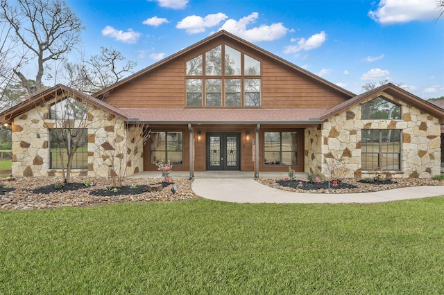28540 Lynnwood Ln, Hempstead, TX 77445 - view of front facade with stone siding, french doors, and a front yard