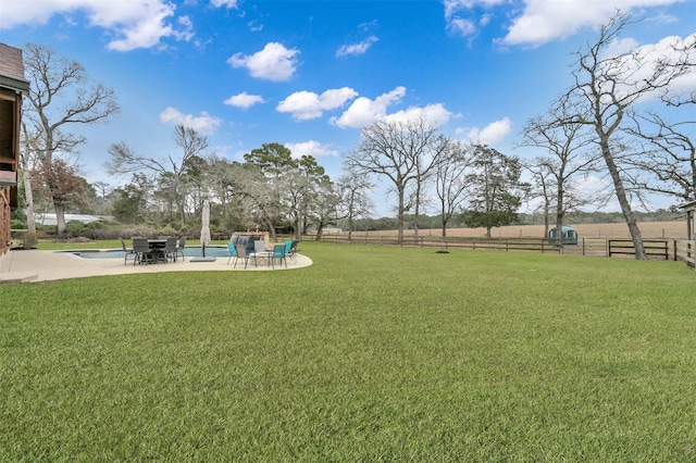 view of yard with a fenced in pool and a patio area