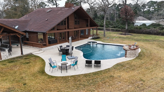 view of swimming pool with a lawn, a patio, and an in ground hot tub