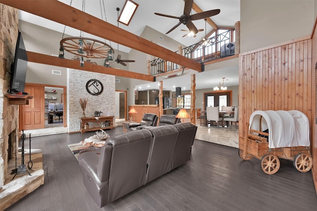 living room with high vaulted ceiling, dark hardwood / wood-style floors, ceiling fan with notable chandelier, and beam ceiling