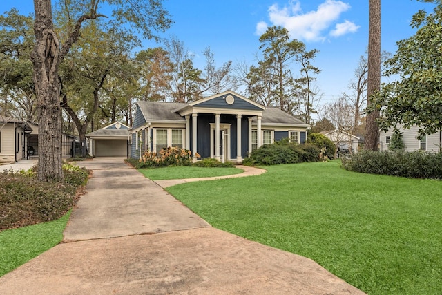 view of front facade featuring a garage, a front lawn, and an outdoor structure