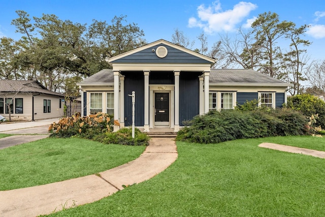 neoclassical home featuring a front yard