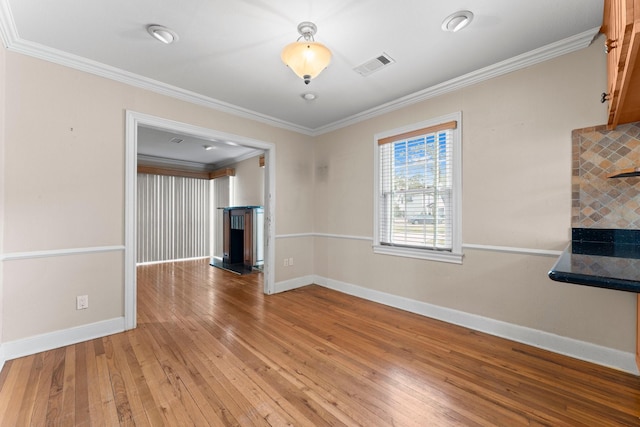 interior space featuring hardwood / wood-style floors and ornamental molding