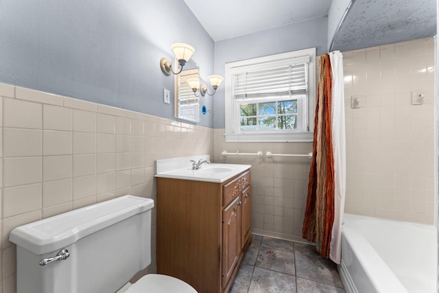 full bathroom featuring tile walls, toilet, vanity, and shower / bathtub combination with curtain