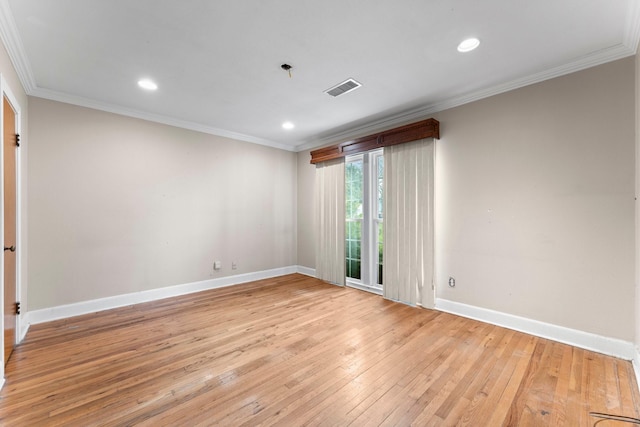 empty room featuring light hardwood / wood-style flooring and ornamental molding