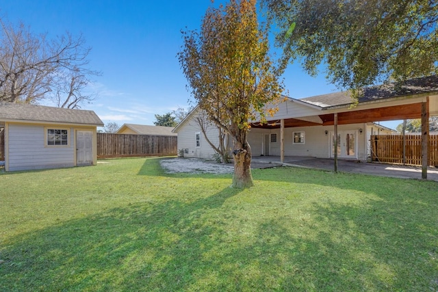 view of yard featuring a patio and an outdoor structure