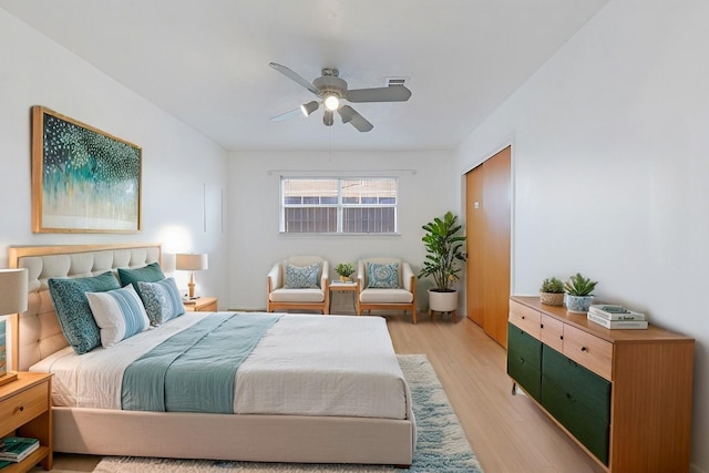 bedroom featuring light hardwood / wood-style floors and ceiling fan