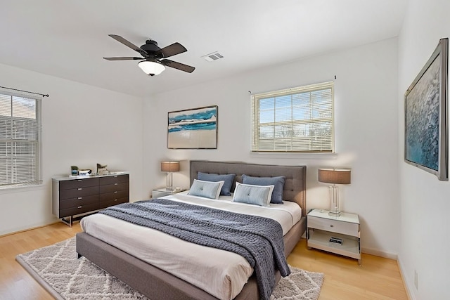 bedroom featuring light hardwood / wood-style floors and ceiling fan