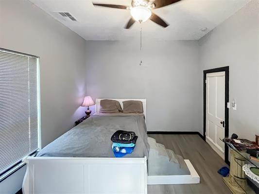 unfurnished bedroom featuring ceiling fan and wood-type flooring