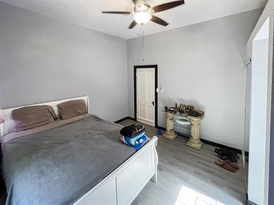 bedroom with ceiling fan and light hardwood / wood-style floors