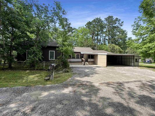 ranch-style home featuring a carport