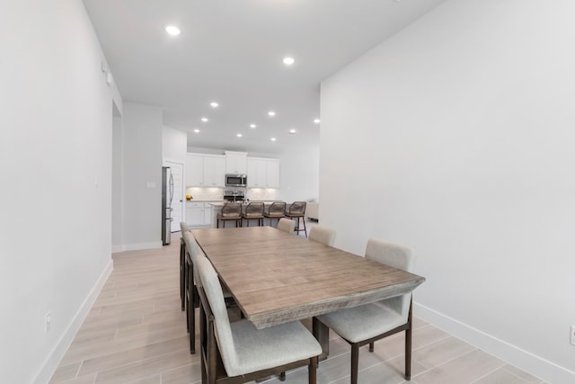 dining area with light hardwood / wood-style floors