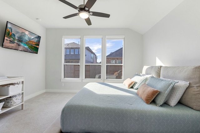 carpeted bedroom with ceiling fan and vaulted ceiling