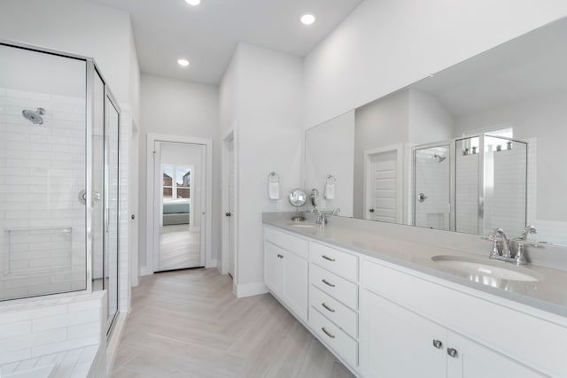 bathroom featuring parquet floors, vanity, and walk in shower