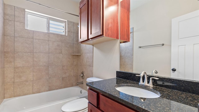 full bathroom with tiled shower / bath combo, vanity, and toilet