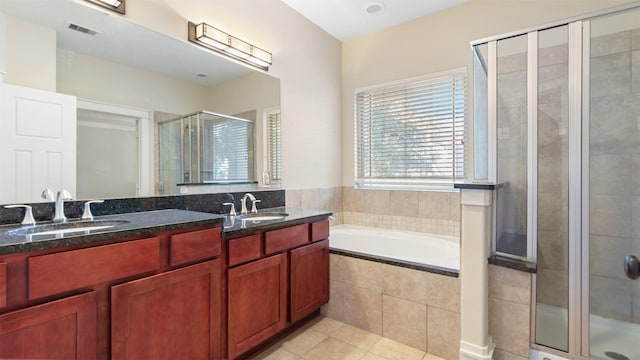 bathroom with tile patterned flooring, vanity, and separate shower and tub