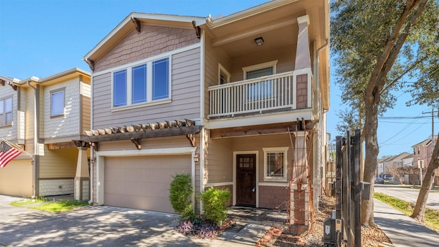 townhome / multi-family property featuring a balcony and a garage