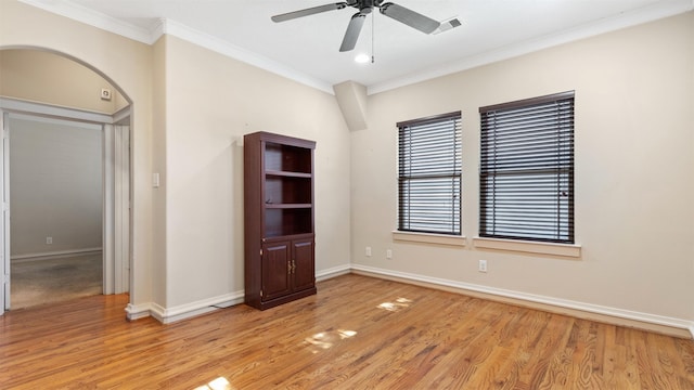 empty room with crown molding, ceiling fan, and light hardwood / wood-style flooring