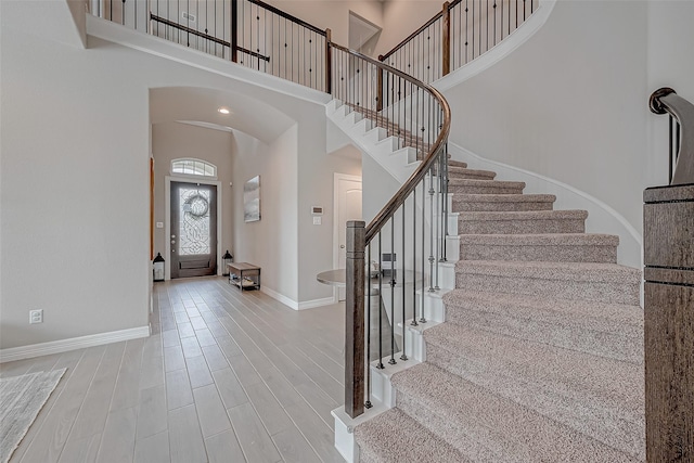 entryway with a high ceiling and light hardwood / wood-style floors