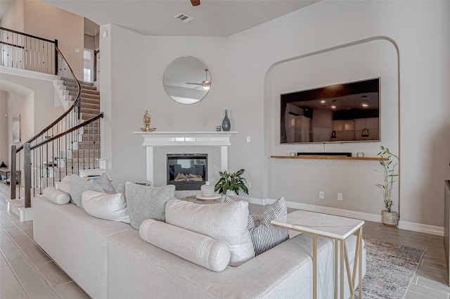 living room with a fireplace and ceiling fan