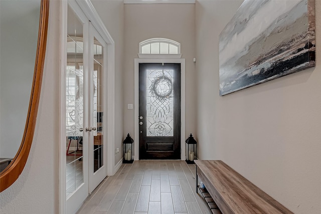 foyer entrance featuring light hardwood / wood-style floors and french doors